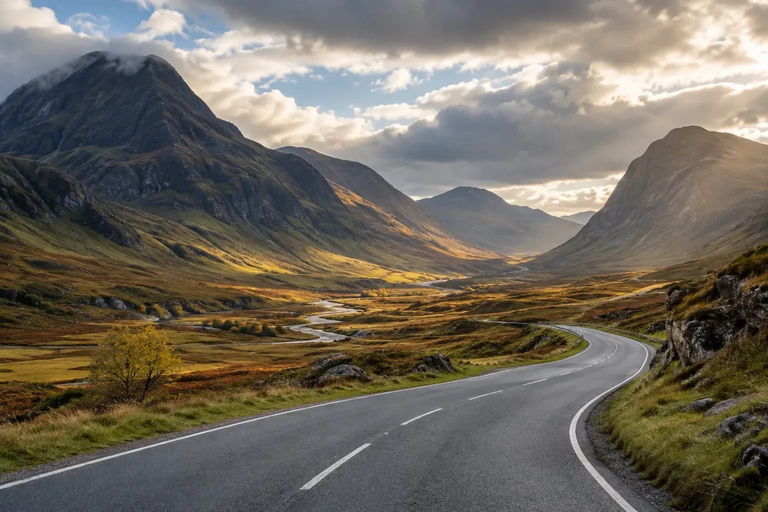 A winding road through the mountains of the Scottish Highlands